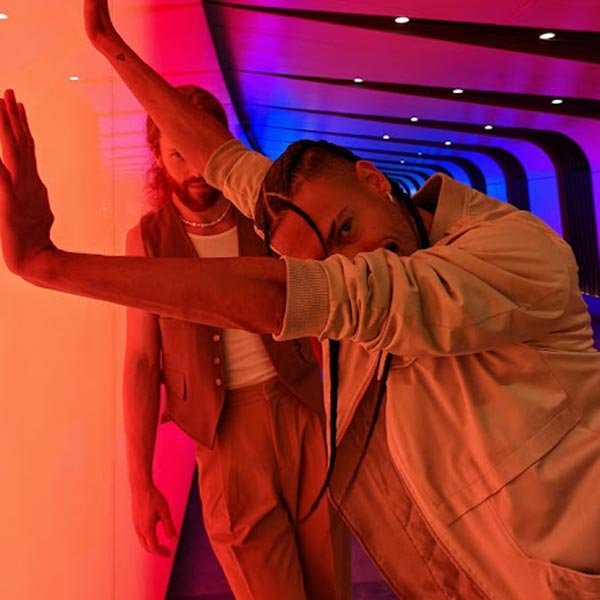 man leaning on neon light wall