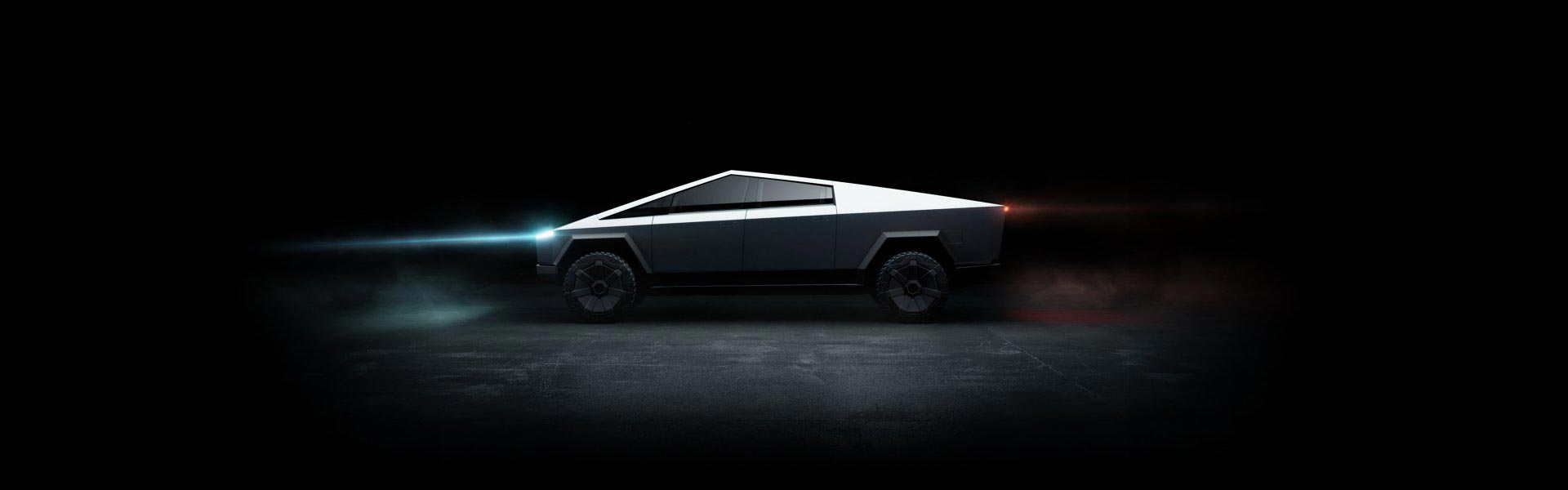 image side shot of tesla cybertruck in dark garage